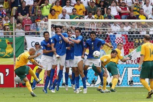 Italy defend the ensuing free kick following the red card